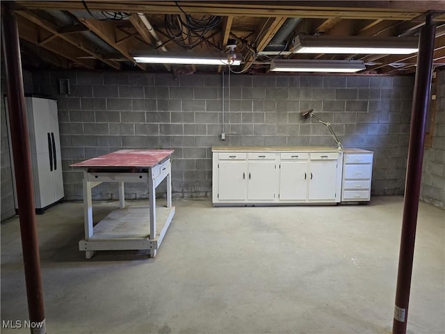 basement featuring white fridge