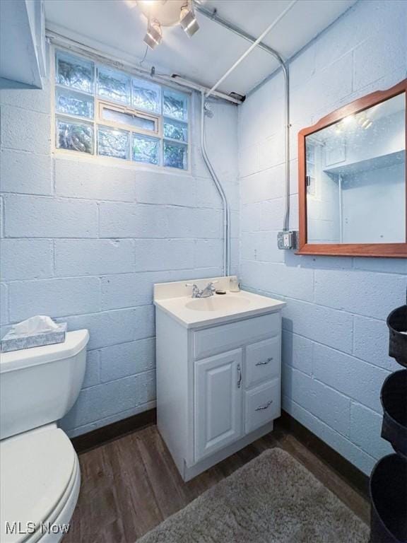 bathroom featuring hardwood / wood-style flooring, toilet, and vanity