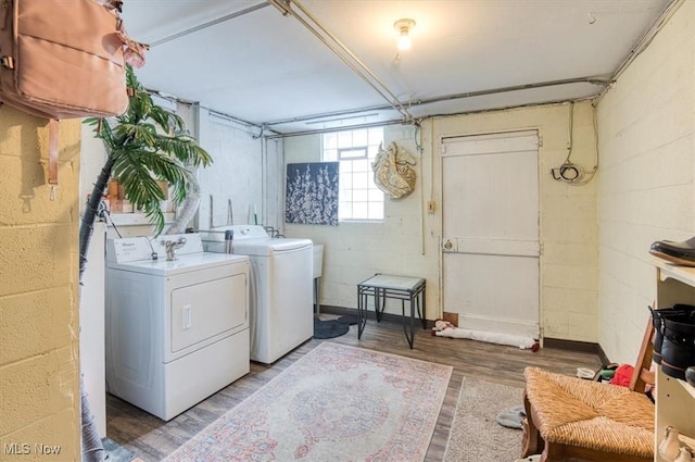 laundry room featuring washer and clothes dryer and wood-type flooring