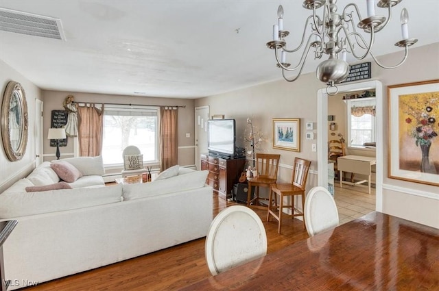 living room with an inviting chandelier and hardwood / wood-style floors