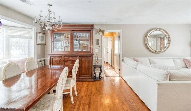 dining space featuring a notable chandelier and light hardwood / wood-style flooring