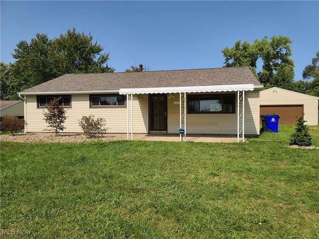 ranch-style home with a garage, a patio area, a front lawn, and an outbuilding