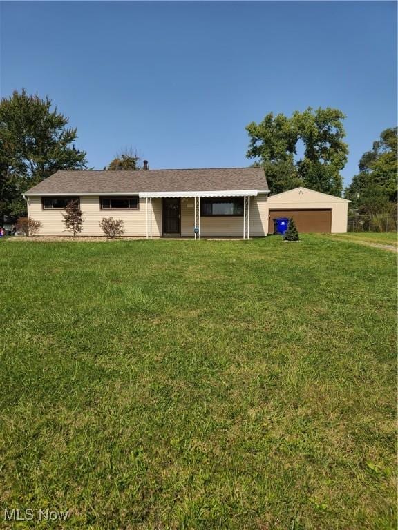 ranch-style house featuring a garage and a front lawn