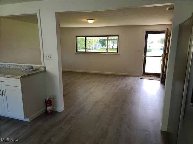 unfurnished dining area featuring dark hardwood / wood-style floors