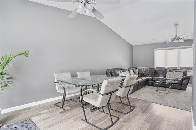 dining room with ceiling fan, light hardwood / wood-style flooring, and lofted ceiling