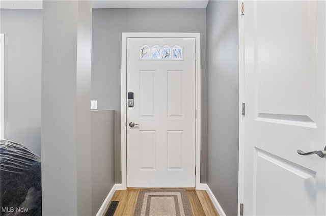 doorway with hardwood / wood-style flooring