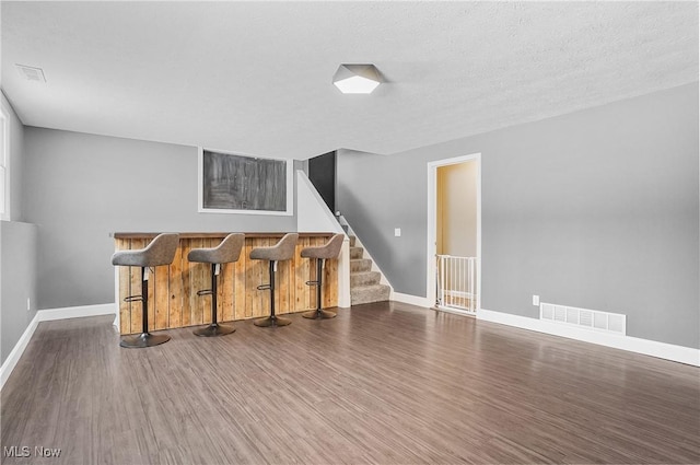 interior space with dark hardwood / wood-style floors and a textured ceiling