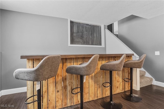 bar featuring dark hardwood / wood-style flooring