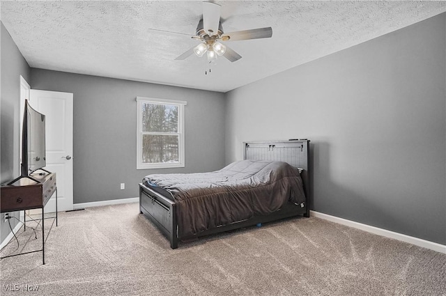 carpeted bedroom featuring ceiling fan and a textured ceiling