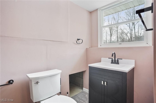 bathroom featuring vanity and toilet