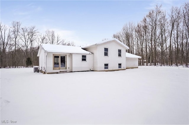 snow covered house with cooling unit