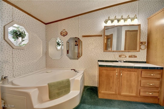 bathroom with vanity, ornamental molding, a textured ceiling, and a bathing tub