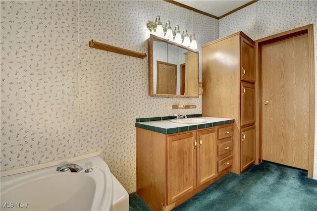 bathroom with crown molding, a tub to relax in, and vanity