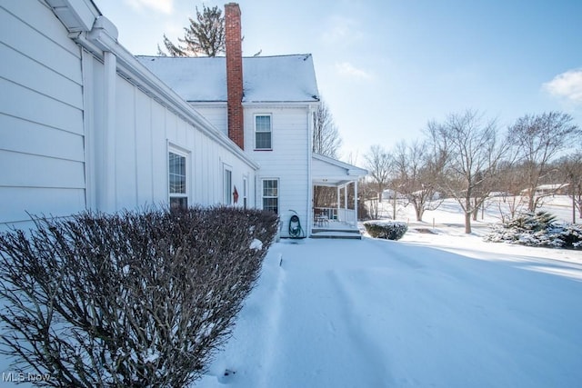 view of snow covered exterior featuring a porch