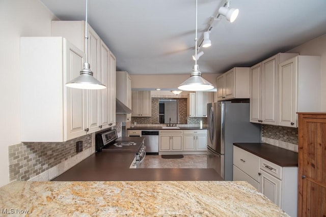 kitchen featuring white cabinetry, decorative backsplash, decorative light fixtures, stainless steel appliances, and wall chimney exhaust hood