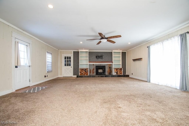 2040 E Middletown Rd, Poland, OH 44514 - unfurnished living room with crown molding, ceiling fan, carpet flooring, a tiled fireplace, and baseboards
