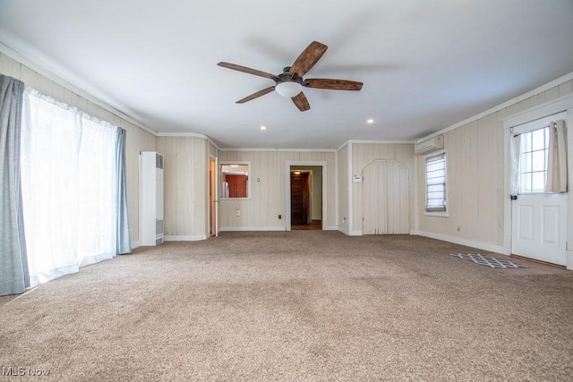 2040 E Middletown Rd, Poland, OH 44514 - unfurnished living room with crown molding, a ceiling fan, carpet floors, recessed lighting, and wood walls