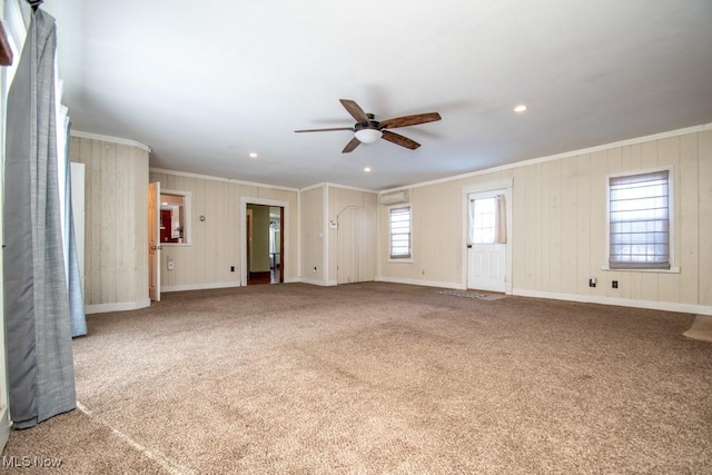 2040 E Middletown Rd, Poland, OH 44514 - unfurnished living room with ornamental molding, a ceiling fan, carpet, baseboards, and wood walls