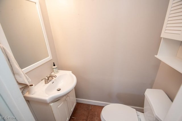 bathroom with vanity, toilet, and tile patterned flooring