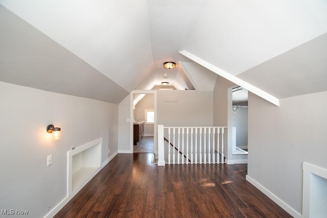 bonus room with dark hardwood / wood-style floors and lofted ceiling