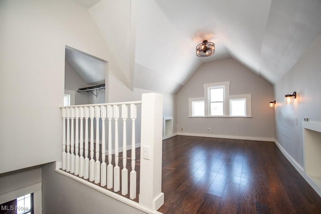 bonus room featuring vaulted ceiling and dark hardwood / wood-style flooring