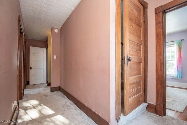 hallway with a textured ceiling