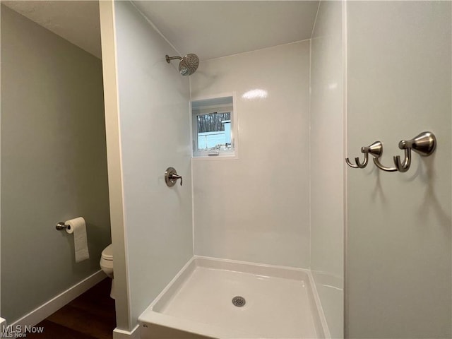 bathroom featuring toilet and a shower