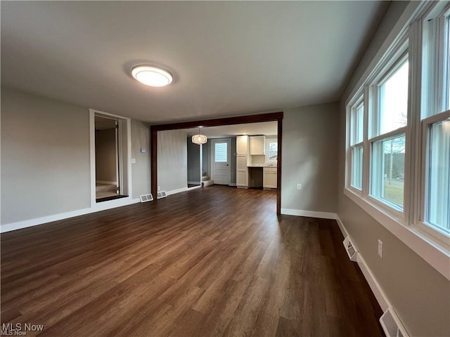 empty room with dark wood-type flooring