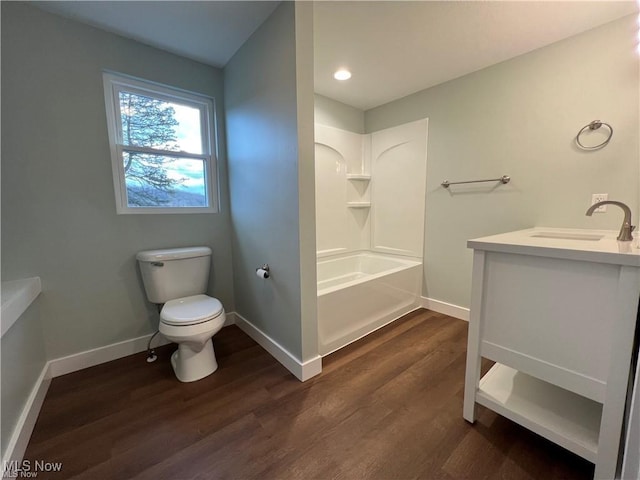 full bathroom featuring hardwood / wood-style flooring, toilet, vanity, and shower / washtub combination