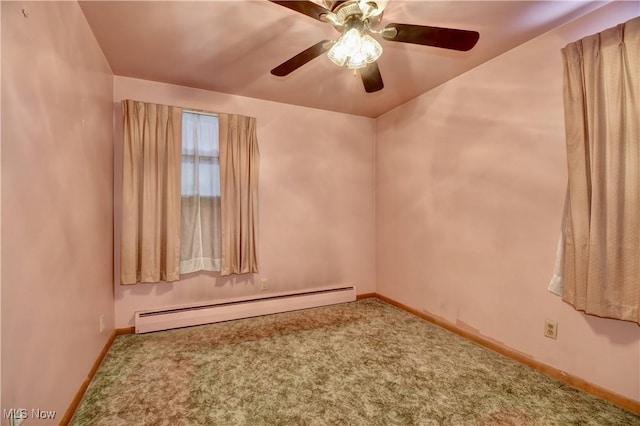 carpeted empty room with ceiling fan and a baseboard radiator