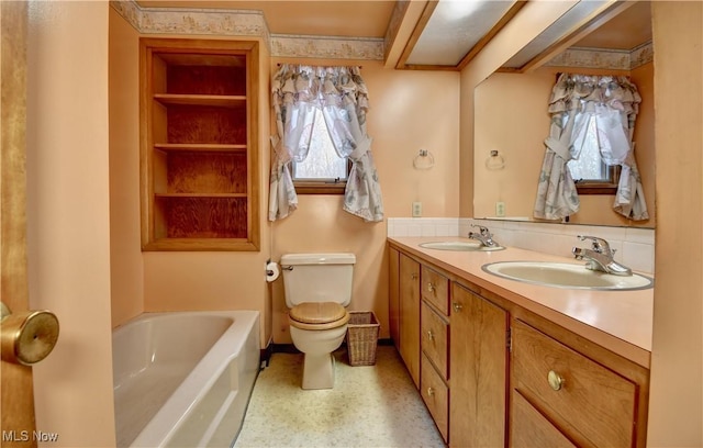 bathroom featuring vanity, toilet, and a bathing tub