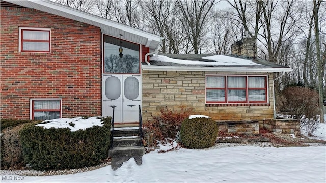 view of snow covered property entrance