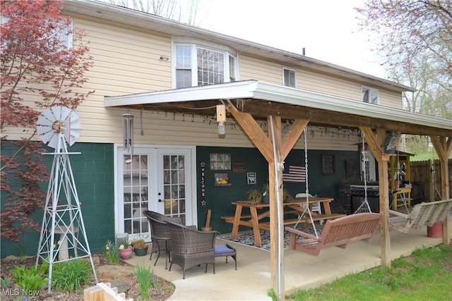 rear view of property with a patio and french doors