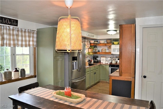 kitchen with appliances with stainless steel finishes and green cabinets