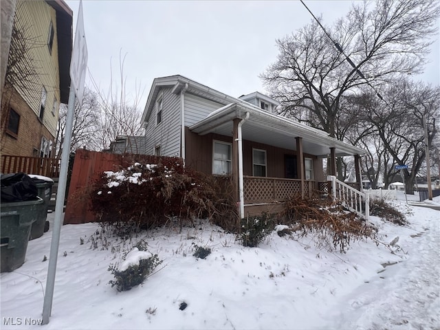 view of snow covered exterior featuring covered porch