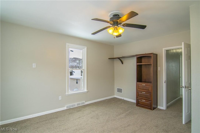 unfurnished bedroom featuring ceiling fan and light colored carpet