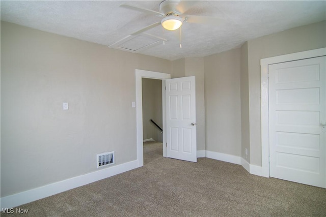 unfurnished bedroom featuring ceiling fan and carpet