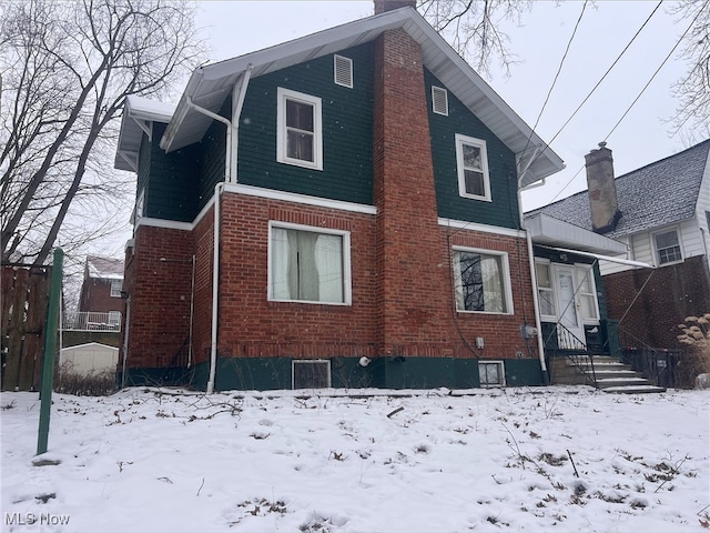 view of snow covered rear of property