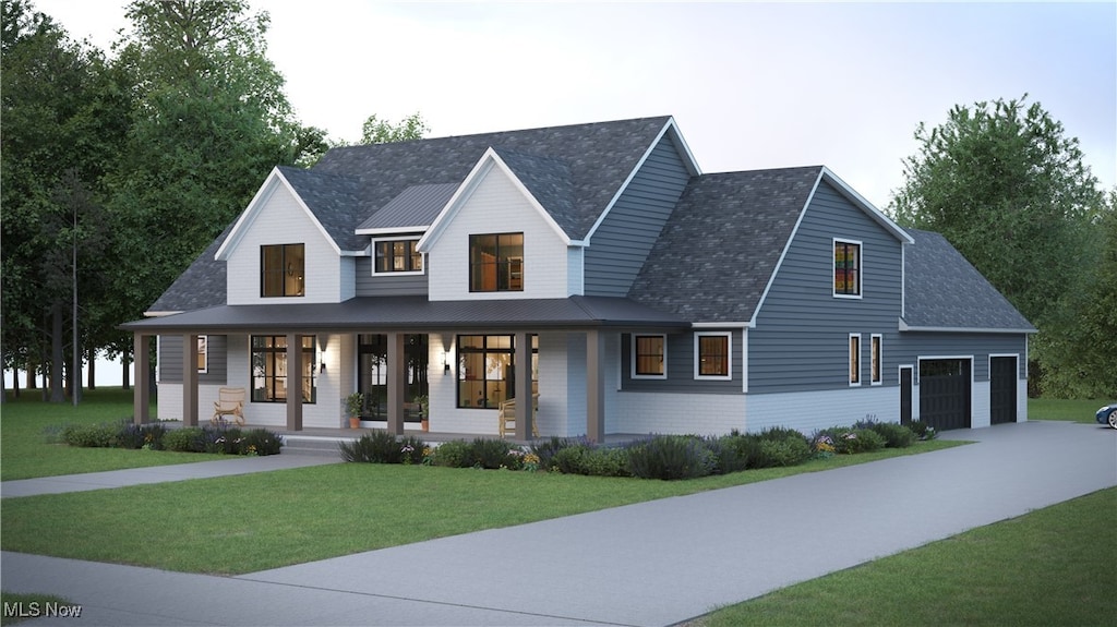 view of front of house with covered porch, a garage, and a front lawn