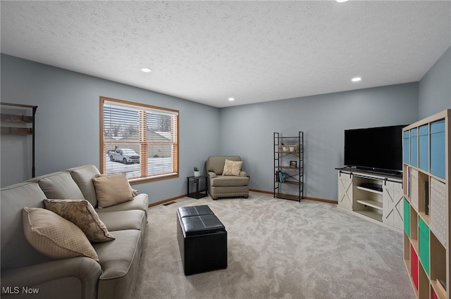 carpeted living room with a textured ceiling