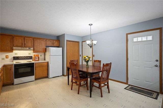 kitchen with decorative light fixtures, white appliances, and a chandelier