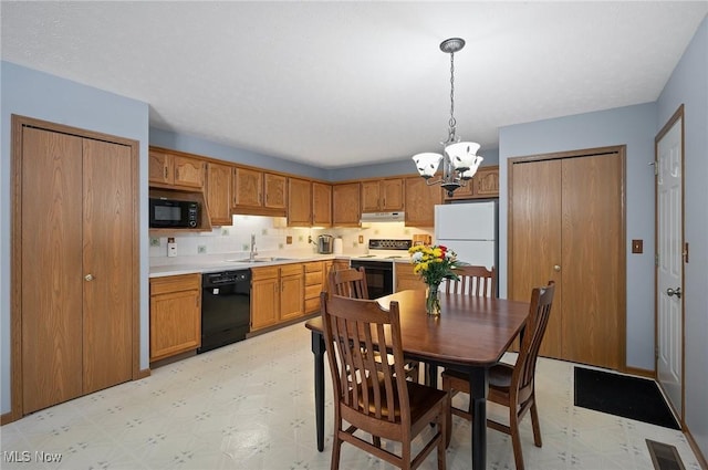 kitchen featuring decorative light fixtures, sink, black appliances, decorative backsplash, and an inviting chandelier