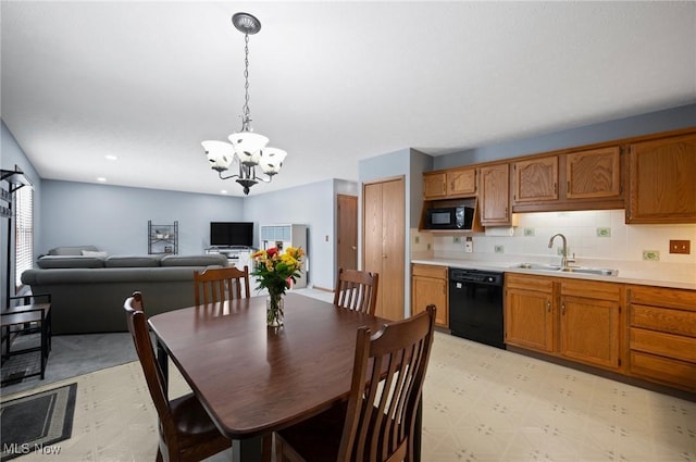 dining room with sink and a chandelier