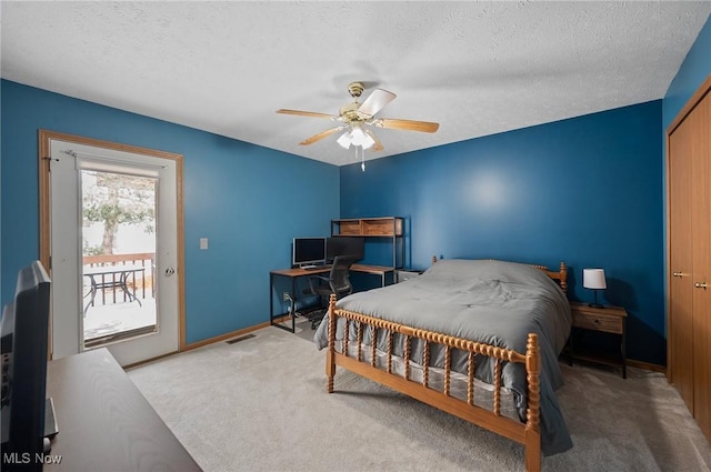 bedroom with ceiling fan, carpet, access to outside, and a textured ceiling