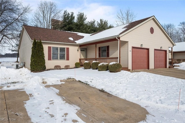 single story home with a porch, a garage, and central AC unit