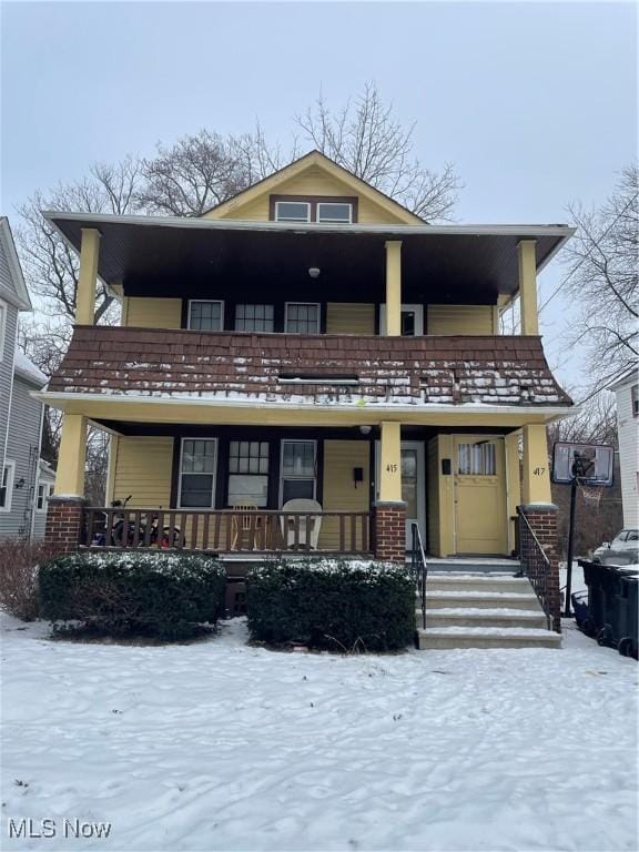 front of property featuring a porch and a balcony