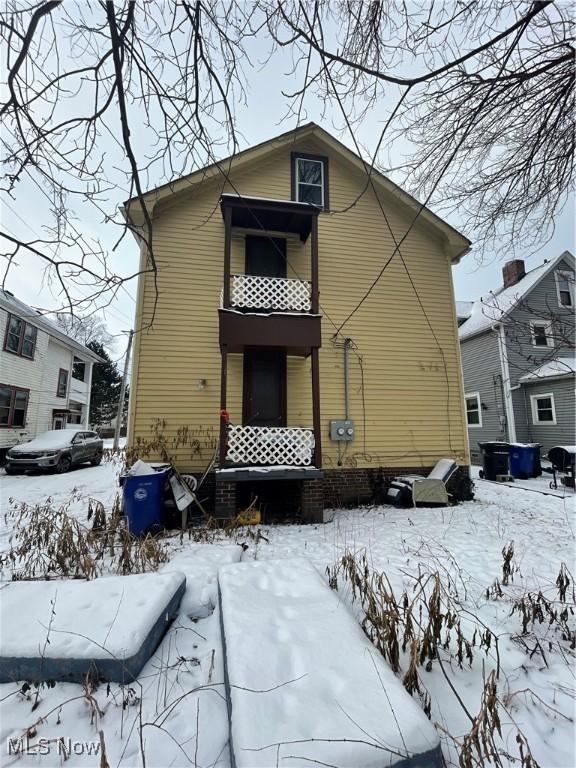 snow covered house with a balcony