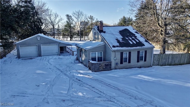 view of front of property featuring a garage and an outbuilding