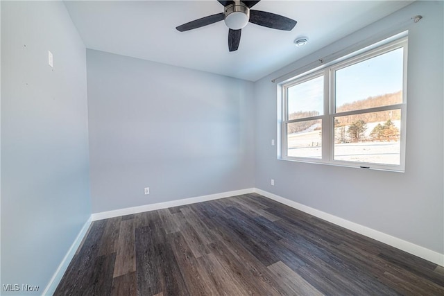 empty room with ceiling fan and dark hardwood / wood-style flooring