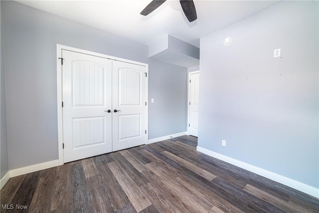 unfurnished bedroom featuring a closet, ceiling fan, and dark hardwood / wood-style flooring